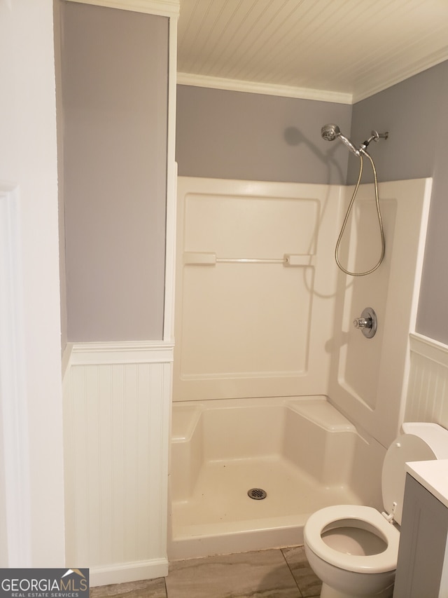 bathroom with vanity, walk in shower, toilet, and ornamental molding