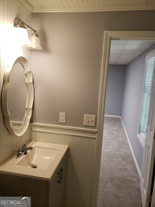 bathroom featuring vanity, a paneled ceiling, and a healthy amount of sunlight