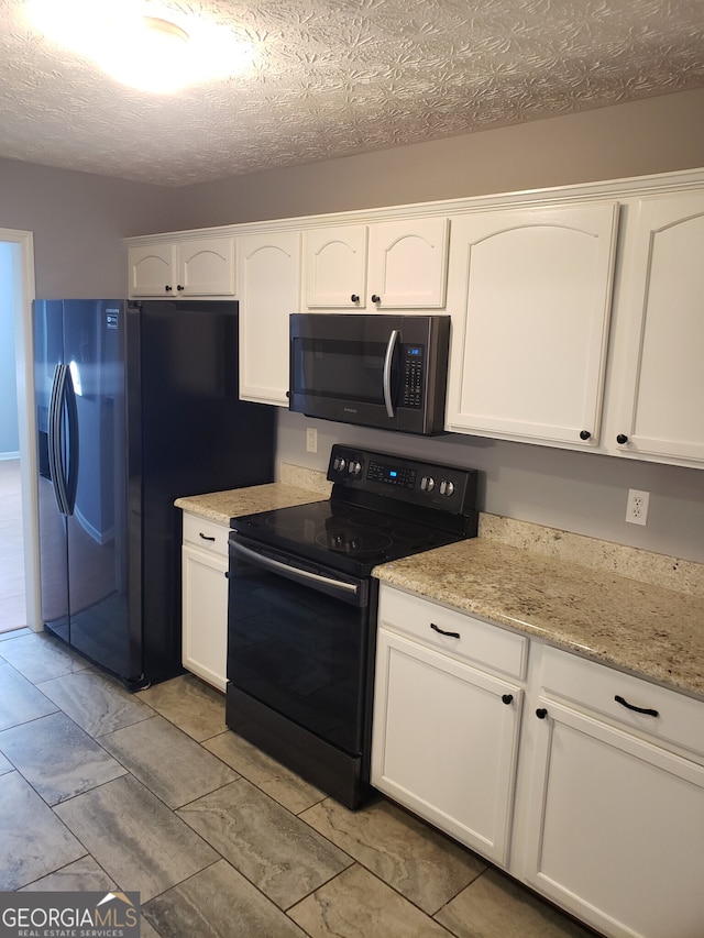 kitchen with light tile patterned floors, black appliances, a textured ceiling, and white cabinets