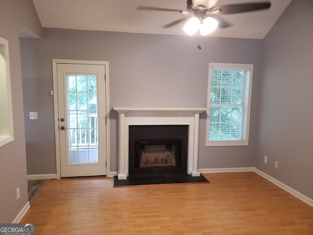 unfurnished living room with light hardwood / wood-style flooring, lofted ceiling, and ceiling fan