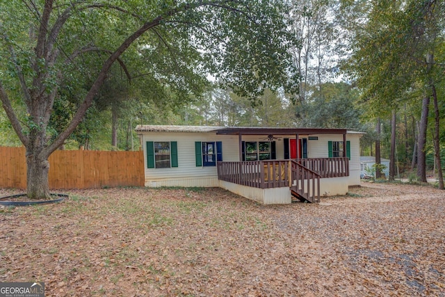 view of front of property with a wooden deck and ceiling fan