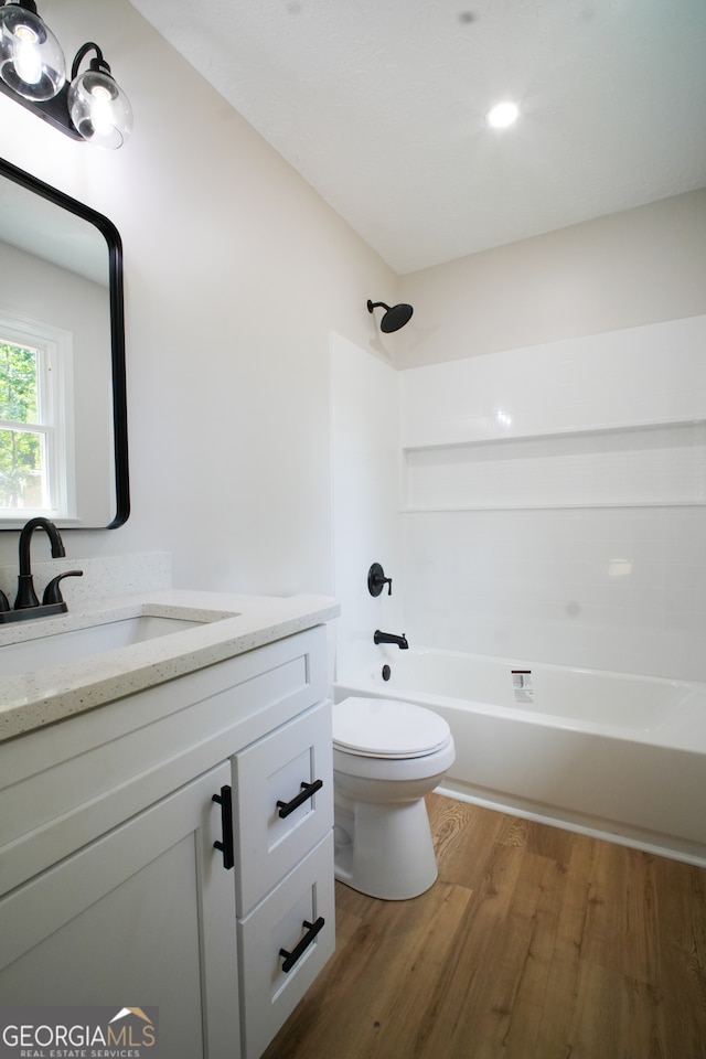 unfurnished bedroom featuring a textured ceiling, a closet, and wood-type flooring