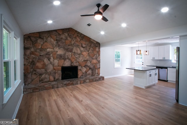 kitchen featuring white cabinets, stainless steel appliances, and wall chimney range hood