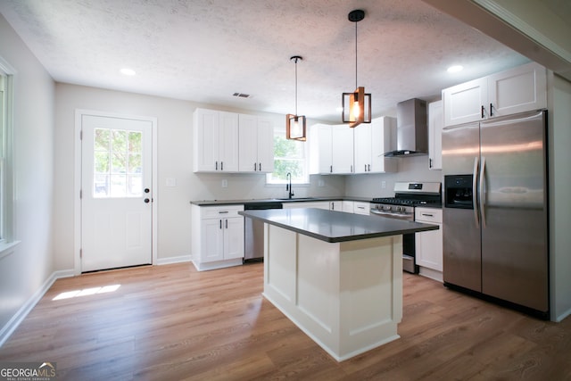 kitchen with white cabinetry, premium range hood, light hardwood / wood-style flooring, and stainless steel appliances