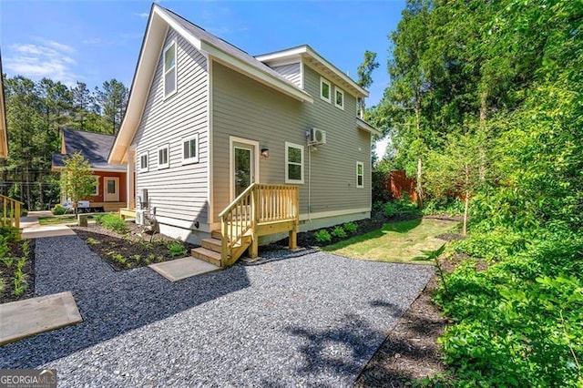 rear view of house featuring a wall mounted AC