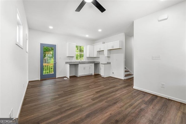 unfurnished living room featuring ceiling fan, dark hardwood / wood-style flooring, and sink