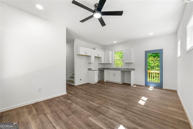 kitchen with white cabinetry, ceiling fan, and hardwood / wood-style flooring