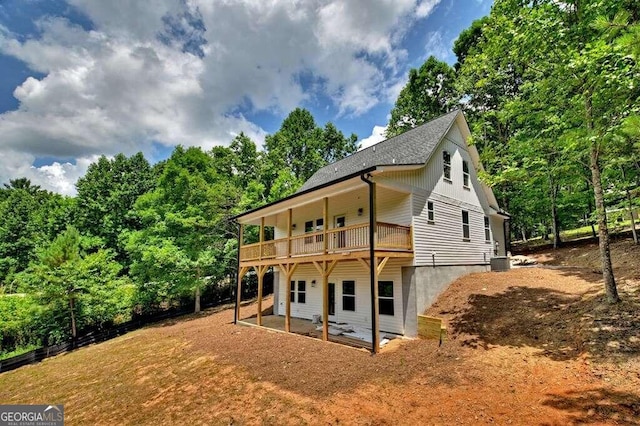 back of property featuring central air condition unit and a balcony