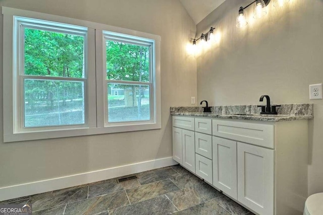 bathroom featuring tile patterned flooring, toilet, and a wealth of natural light