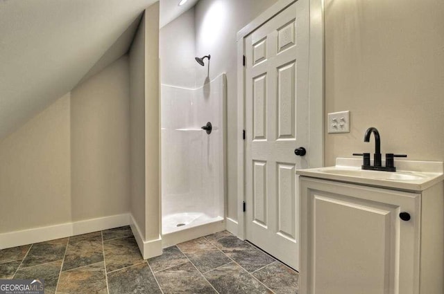 bathroom with vanity, walk in shower, tile patterned flooring, and vaulted ceiling