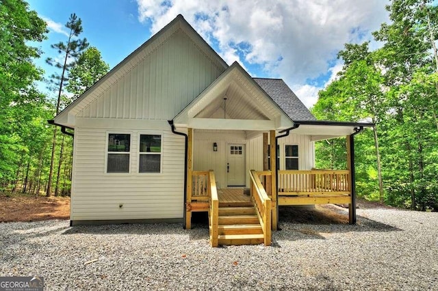 rear view of property with covered porch