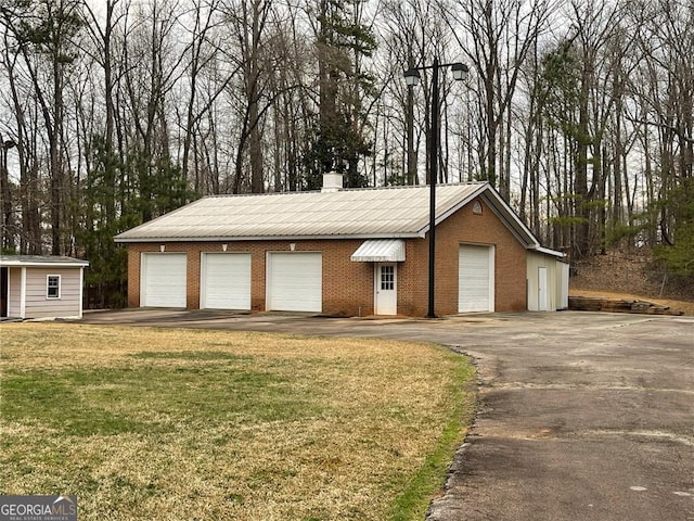 ranch-style home with an outbuilding and a front yard