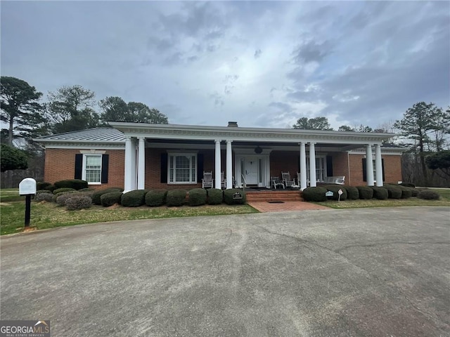 neoclassical / greek revival house featuring a porch