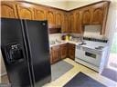 kitchen with black refrigerator with ice dispenser