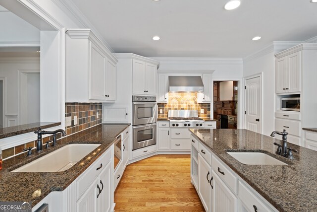 kitchen with sink, decorative backsplash, and wall chimney exhaust hood