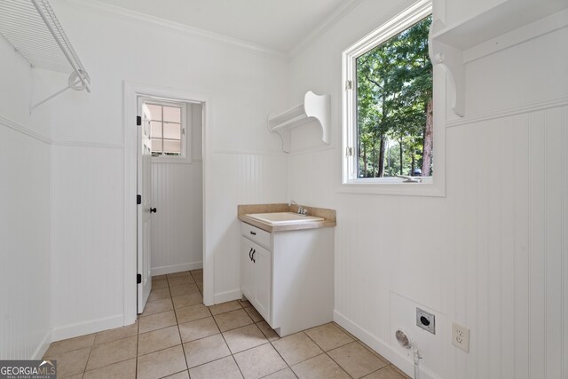 laundry room with sink, light tile patterned flooring, hookup for an electric dryer, and plenty of natural light