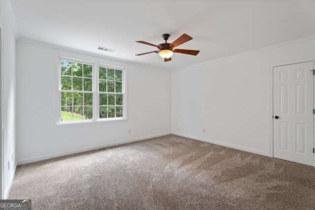 carpeted spare room featuring crown molding and ceiling fan