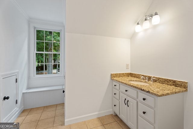 bathroom featuring vanity, ornamental molding, tile patterned flooring, and vaulted ceiling