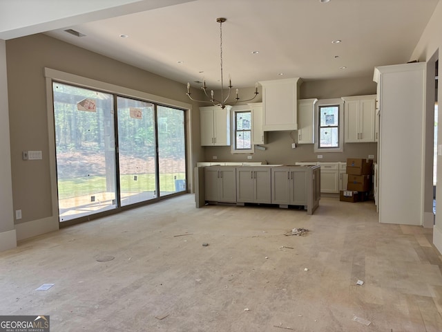 kitchen featuring pendant lighting, recessed lighting, white cabinetry, and visible vents