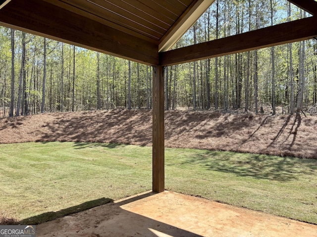 view of yard featuring a view of trees and a patio area