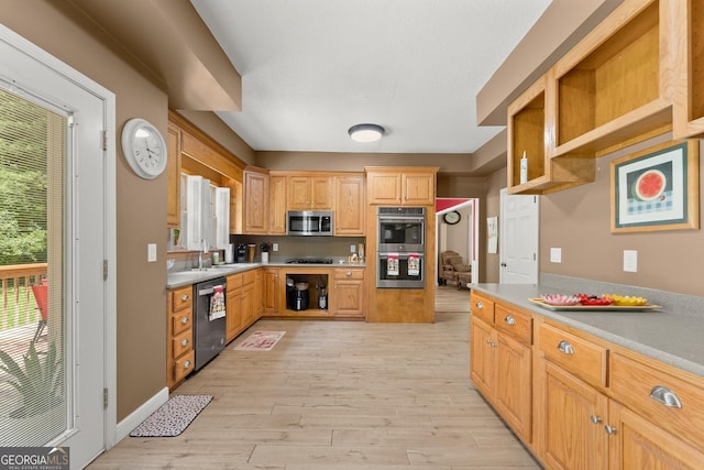 kitchen featuring sink, light brown cabinets, appliances with stainless steel finishes, and light wood-type flooring