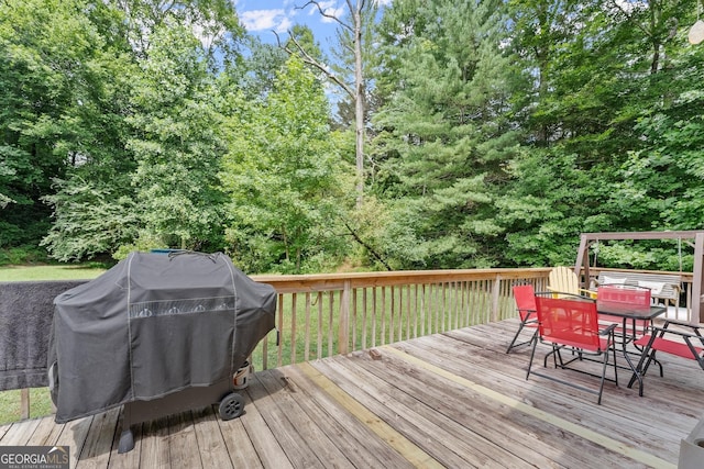 wooden terrace featuring a grill