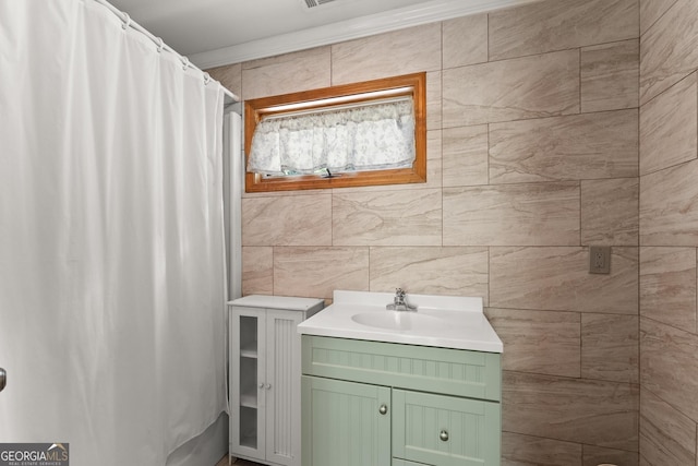 bathroom featuring crown molding, a shower with curtain, tile walls, and vanity