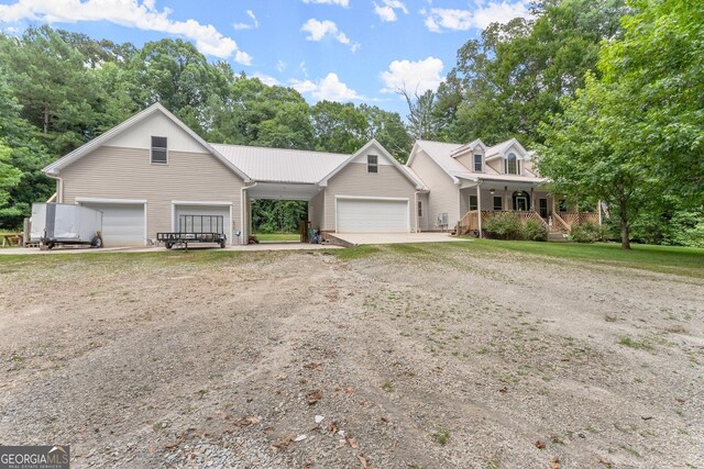 view of front of home with covered porch and a garage