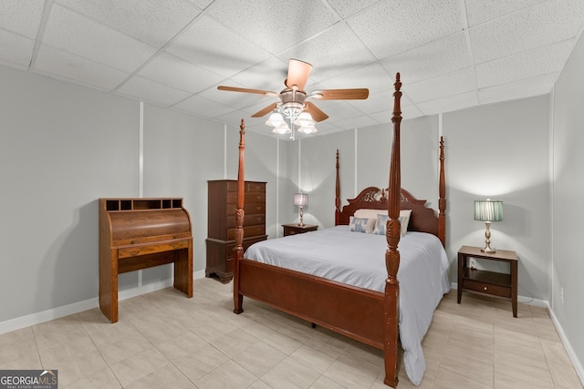 bedroom featuring a drop ceiling and ceiling fan