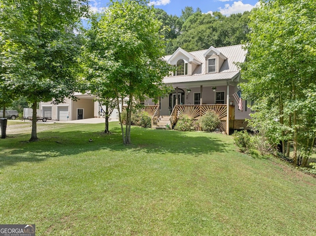 view of front of house featuring covered porch, a front yard, and a garage