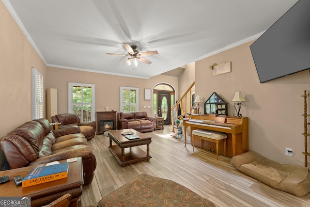 living room featuring ceiling fan and crown molding