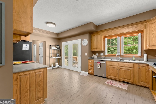 kitchen with light hardwood / wood-style flooring, french doors, sink, appliances with stainless steel finishes, and a textured ceiling