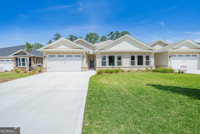 view of front of property featuring a front yard and a garage