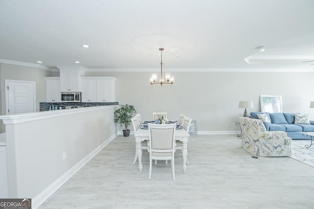 dining room with ceiling fan with notable chandelier and ornamental molding