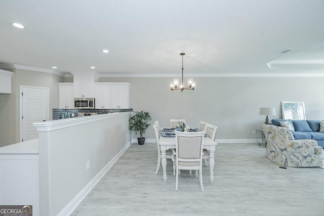 dining space featuring a chandelier and ornamental molding