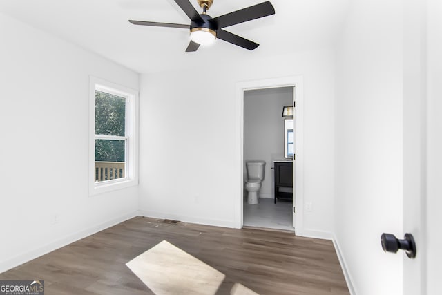 unfurnished room featuring ceiling fan and dark wood-type flooring