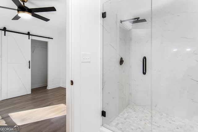 bathroom with ceiling fan, wood-type flooring, and walk in shower