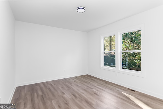 spare room featuring light hardwood / wood-style floors