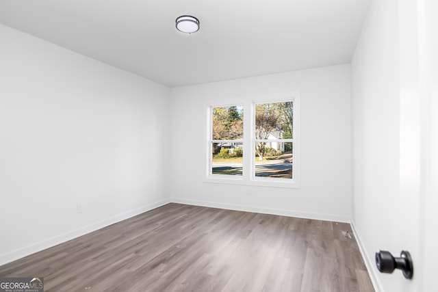 spare room featuring hardwood / wood-style floors