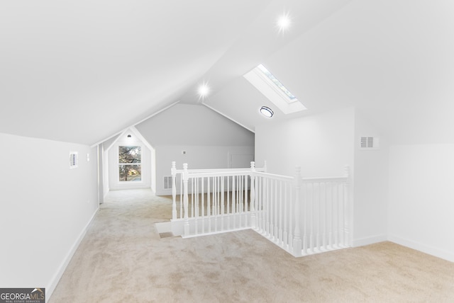 bonus room featuring light colored carpet and vaulted ceiling with skylight