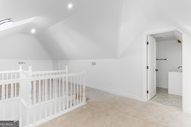 bonus room featuring light colored carpet and lofted ceiling