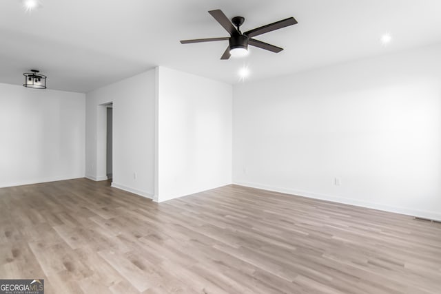 spare room featuring light hardwood / wood-style flooring and ceiling fan