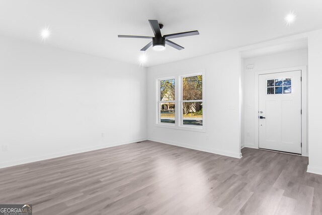 foyer with light hardwood / wood-style floors and ceiling fan