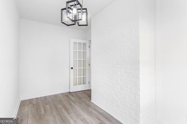 interior space with light wood-type flooring and an inviting chandelier