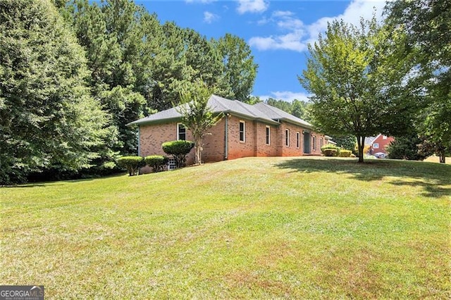 view of side of property with a lawn