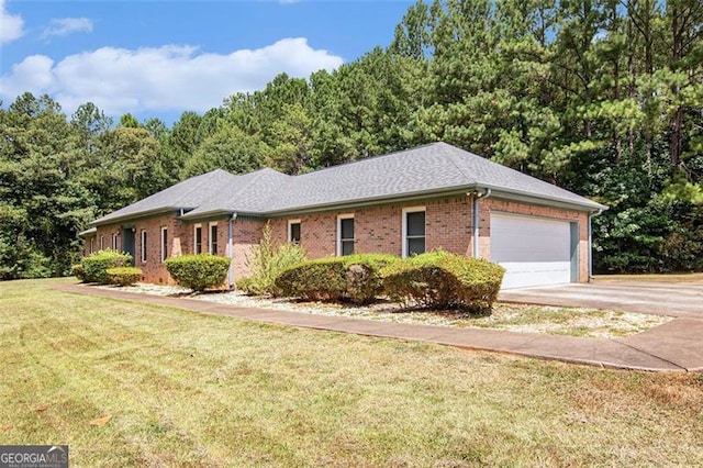 ranch-style home featuring a garage and a front lawn