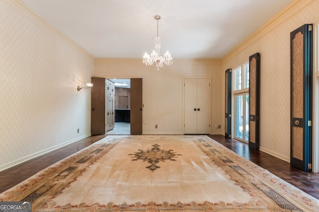 unfurnished room with a notable chandelier, dark hardwood / wood-style flooring, and crown molding