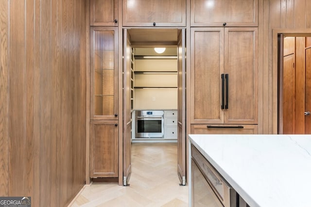 kitchen featuring light parquet floors and stainless steel oven