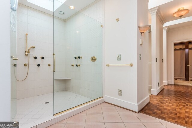 bathroom featuring a shower with door, parquet floors, and crown molding