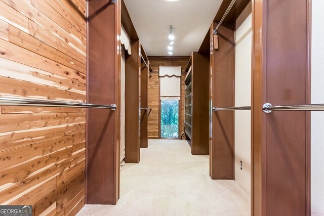 spacious closet with light colored carpet